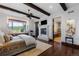 Serene main bedroom features a fireplace, a window seat, exposed wood beams and an ensuite bathroom at 7208 Raphael Ln, Littleton, CO 80125