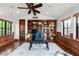 Stylish home office with hardwood floors, built-in shelving, and ample natural light at 7208 Raphael Ln, Littleton, CO 80125