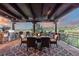 Open air patio with outdoor kitchen, grill, dining set, and panoramic views of the surrounding landscape at 7208 Raphael Ln, Littleton, CO 80125