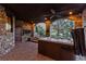 An inviting stone patio features a hot tub, arched openings, and views of the outdoor staircase at 7208 Raphael Ln, Littleton, CO 80125