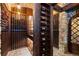 Walk-in wine cellar with wood wine racks and brick floors for storing wines in a climate-controlled environment at 7208 Raphael Ln, Littleton, CO 80125