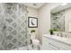 Stylish bathroom featuring decorative shower tile, new vanity and a glass shower door at 9777 W 75Th Way, Arvada, CO 80005