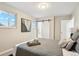 Serene bedroom featuring lots of natural light, sliding barn door, and soothing decor at 9777 W 75Th Way, Arvada, CO 80005