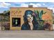 Exterior view of Agave Taco Bar with a vibrant mural and outdoor seating, showcasing its inviting atmosphere at 451 S Franklin St, Denver, CO 80209
