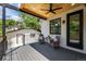 Cozy back porch with a ceiling fan, wicker chairs, small table, and access to the backyard at 451 S Franklin St, Denver, CO 80209