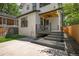 Exterior view of home with a covered patio, a freshly stained deck and ample parking space at 451 S Franklin St, Denver, CO 80209