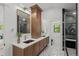 Bathroom featuring double sink vanity, mosaic tile floor, and glass shower, creating a sleek and functional space at 451 S Franklin St, Denver, CO 80209