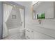 Bright bathroom features a shower with curtain, marble countertop and mosaic tile flooring, exuding elegance at 451 S Franklin St, Denver, CO 80209