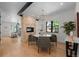 Elegant dining room with a modern chandelier, stone fireplace, and view into the living room at 451 S Franklin St, Denver, CO 80209