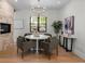 Charming dining room featuring a round table, stylish chairs, and view of the backyard through a window at 451 S Franklin St, Denver, CO 80209