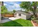 Backyard view of detached one-car garage with fresh paint and a well manicured lawn at 451 S Franklin St, Denver, CO 80209