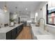Modern kitchen showcasing a large island, stainless steel appliances, white countertops, and a stylish sink at 451 S Franklin St, Denver, CO 80209