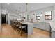 Bright, open kitchen with an island, modern appliances, and hardwood floors at 451 S Franklin St, Denver, CO 80209