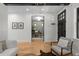 Open-concept living room with hardwood floors and a view of the front door and a cozy office at 451 S Franklin St, Denver, CO 80209