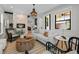 Cozy living room featuring a stone fireplace, a comfortable couch, and a view into the dining room and kitchen at 451 S Franklin St, Denver, CO 80209