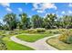 Scenic park featuring winding walking paths, lush green lawns, and vibrant flowerbeds with mature trees on a sunny day at 451 S Franklin St, Denver, CO 80209