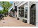 Inviting retail storefronts with large display windows, potted plants, and a welcoming sidewalk lined with shops at 451 S Franklin St, Denver, CO 80209