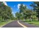 A paved path winds through the lush greenery of Washington Park on a sunny day in Denver at 451 S Franklin St, Denver, CO 80209