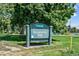Well maintained sign for Denver's Washington Park, surrounded by mature trees and a lake in the background at 451 S Franklin St, Denver, CO 80209