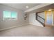 Finished basement has a bright window, a stairway, and neutral carpeting and paint at 19703 Serenity Springs Pt, Monument, CO 80132