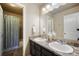 Bathroom featuring double sinks, granite countertop, and a shower and bathtub combo at 19703 Serenity Springs Pt, Monument, CO 80132