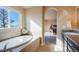 A bright bathroom shows a soaking tub and a basin with natural light from a large window at 19703 Serenity Springs Pt, Monument, CO 80132
