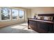 Bedroom with large windows providing natural light and views. Beautiful hardwood bed set on neutral carpet at 19703 Serenity Springs Pt, Monument, CO 80132