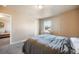 A calm bedroom features a bed, a desk by the window, and carpet at 19703 Serenity Springs Pt, Monument, CO 80132