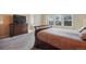 Comfortable bedroom with natural light from windows, neutral carpet, and coordinated furniture at 19703 Serenity Springs Pt, Monument, CO 80132