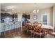 Cozy dining area adjacent to the kitchen features hardwood floors and stylish chandelier lighting at 19703 Serenity Springs Pt, Monument, CO 80132