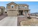 Charming two-story home with a well-manicured front yard, covered porch, and an attached two-car garage at 19703 Serenity Springs Pt, Monument, CO 80132
