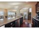 Open-concept kitchen island with modern appliances and a view of living spaces at 19703 Serenity Springs Pt, Monument, CO 80132