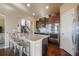 Stylish kitchen island with stainless steel appliances, providing seating and views of the staircase and kitchen at 19703 Serenity Springs Pt, Monument, CO 80132