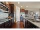 Gourmet kitchen with sleek stainless steel appliances, dark wood cabinetry, and granite countertops at 19703 Serenity Springs Pt, Monument, CO 80132