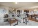 Spacious living room with open floor plan, neutral colors, fireplace, and views into the kitchen and dining area at 19703 Serenity Springs Pt, Monument, CO 80132