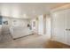Spacious living room featuring a large sofa, carpet, and white trim at 19703 Serenity Springs Pt, Monument, CO 80132