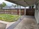 Covered deck overlooks a grassy backyard enclosed by a wooden fence at 4875 Lowell Blvd, Denver, CO 80221