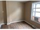 Bright bedroom features wood-look floors and a window with an air conditioning unit at 4875 Lowell Blvd, Denver, CO 80221