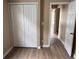 This bedroom features neutral walls, wood-look floors, and a closet with bi-fold doors at 4875 Lowell Blvd, Denver, CO 80221