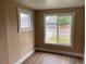 Cozy bedroom showcasing hardwood floors, fresh paint, and windows offering a pleasant street view at 4875 Lowell Blvd, Denver, CO 80221