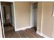 A tidy bedroom featuring hardwood floors, fresh paint, and a closet for easy storage at 4875 Lowell Blvd, Denver, CO 80221