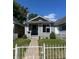 Quaint single-story home with a freshly painted gray exterior, small porch, and white picket fence at 4875 Lowell Blvd, Denver, CO 80221