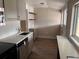 Well-lit kitchen featuring stainless steel appliances, light countertops, updated cabinetry, and wood-look flooring at 4875 Lowell Blvd, Denver, CO 80221