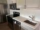 Modern kitchen featuring stainless steel appliances, light countertops, and updated cabinetry at 4875 Lowell Blvd, Denver, CO 80221
