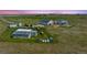 Aerial view of the property including the shop, house and outdoor recreational areas at 5129 S Tom Bay Rd, Bennett, CO 80102