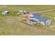 Aerial image of a ranch-style home and outbuildings on a large lot at 5129 S Tom Bay Rd, Bennett, CO 80102