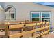 Home exterior with wooden fence around yard and decorative trim around windows at 5129 S Tom Bay Rd, Bennett, CO 80102