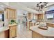 Bright kitchen with oak cabinets and views to the dining area at 5129 S Tom Bay Rd, Bennett, CO 80102