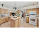 Spacious kitchen with natural wood cabinets offering an open floor plan at 5129 S Tom Bay Rd, Bennett, CO 80102