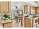 Bright kitchen with wooden cabinets adjacent to a cozy dining space with french doors at 5129 S Tom Bay Rd, Bennett, CO 80102